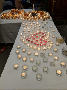 Two tables with tealights that are lit 
