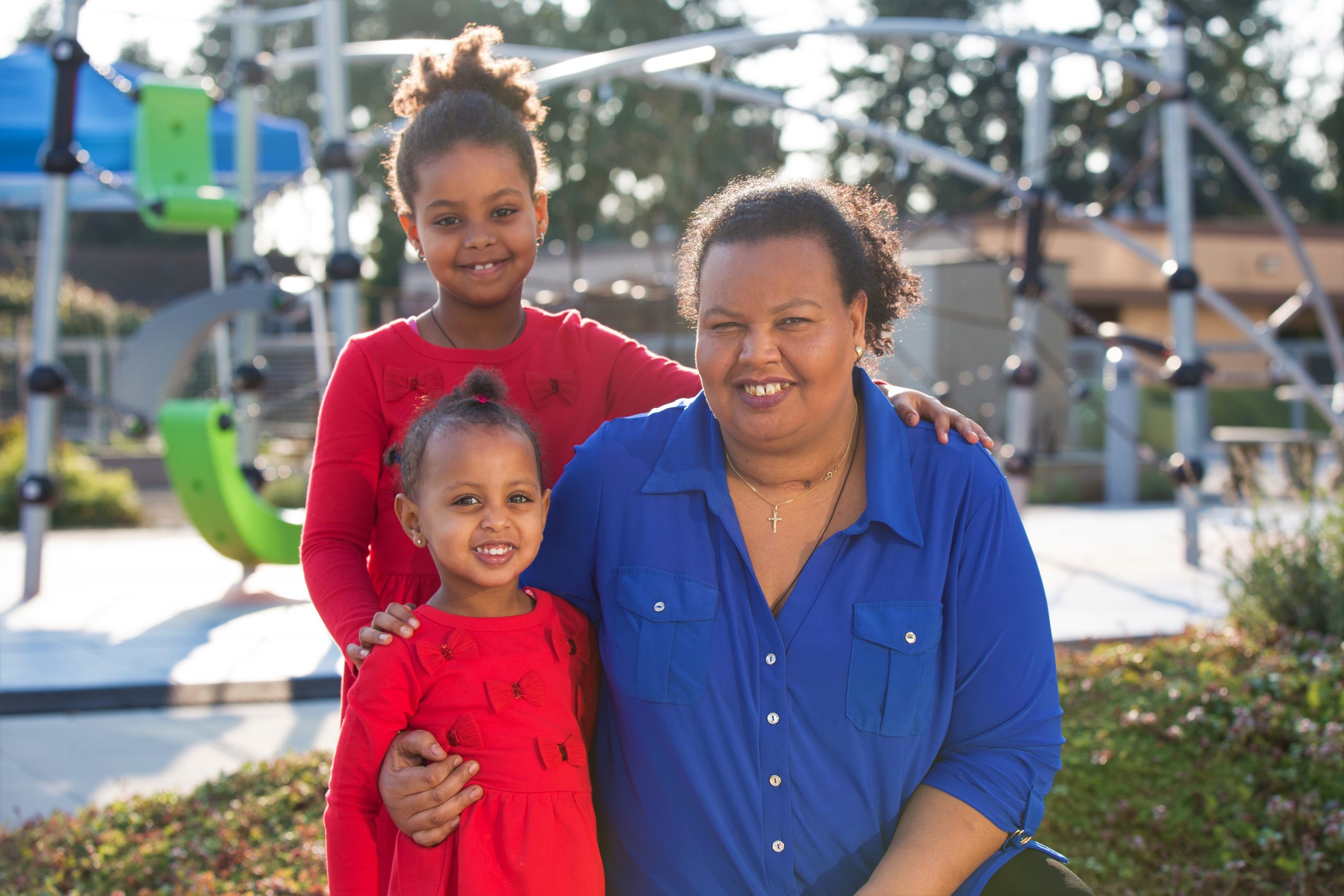 Smiling mom with two daughters