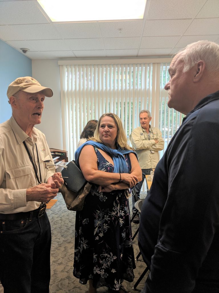 Under Secretary Reeves and Compass Director of Housing Services speak with the Healing Waters volunteers.