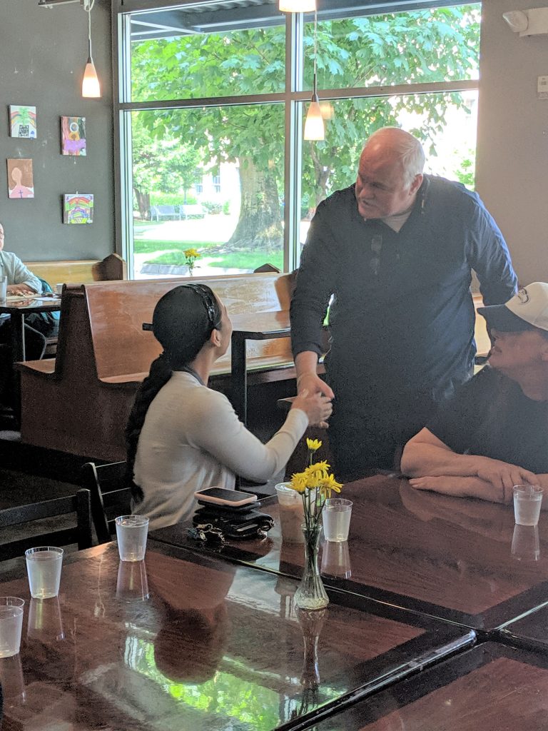 Under Secretary Reeves greets a VA staff member who works with Compass Renton residents.